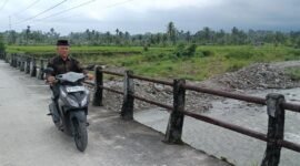 Seorang warga melintasi jembatan darurat di Nagari Anduriang, Kecamatan 2x11 Kayu Tanam, Kabupaten Padang Pariaman, Sumatera Barat