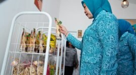 Ketua TP PKK Provinsi Sumatera Selatan melihat dan memilih produk makanan kemasan hasil karya kader PKK saat meresmikan Warung PKK Kota Lubuk Linggau
