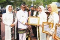 Andra Soni didampingi Ketua TP PKK Banten Tinawati Andra Soni menyerahkan piagam penghargaan Lomba Desa dan Kelurahan serta Satyalancana Karya Satya dalam rangkaian Upacara Peringatan HUT ke-26 Provinsi Banten di KP3B, Serang